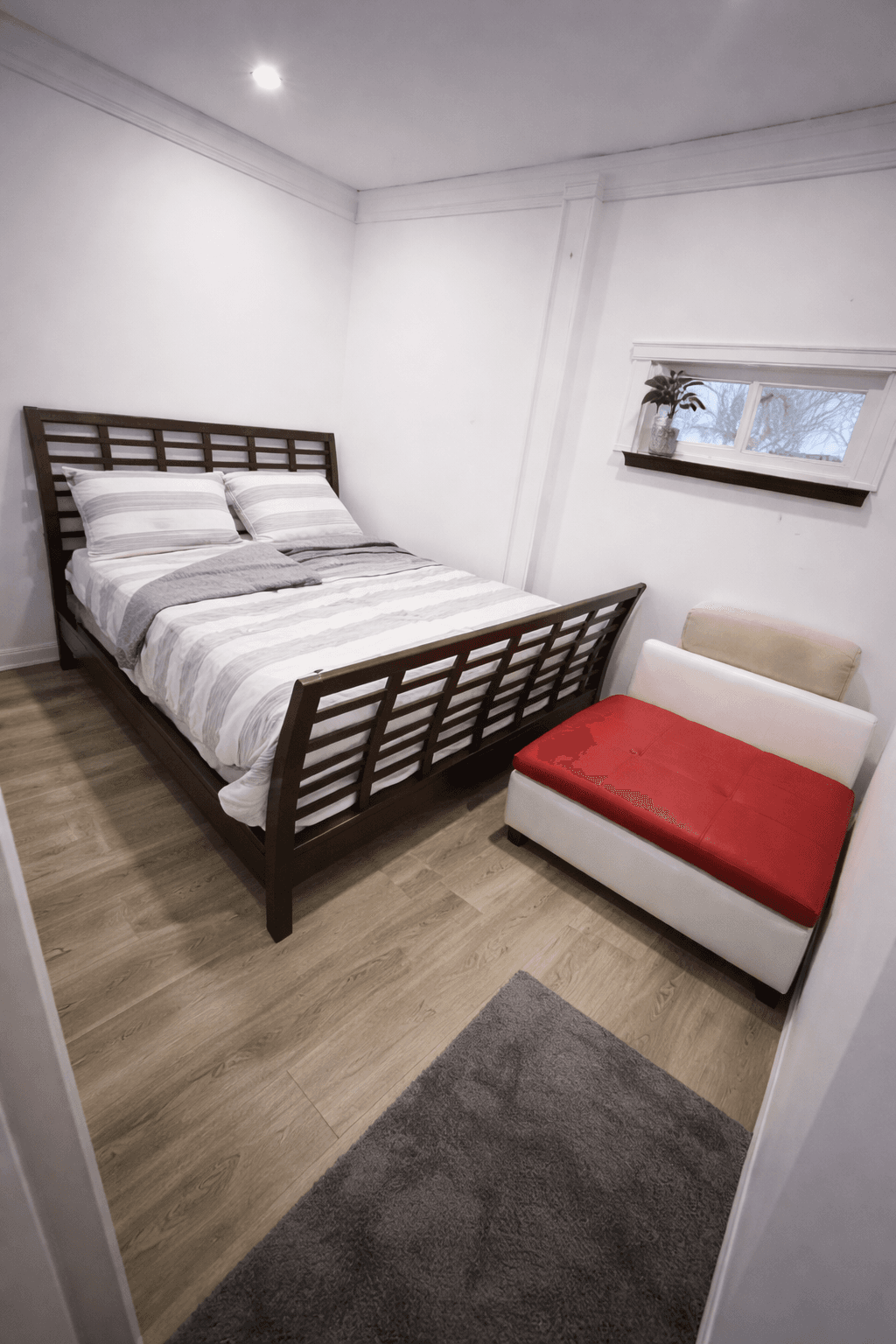 Bedroom view with bed and seating area.