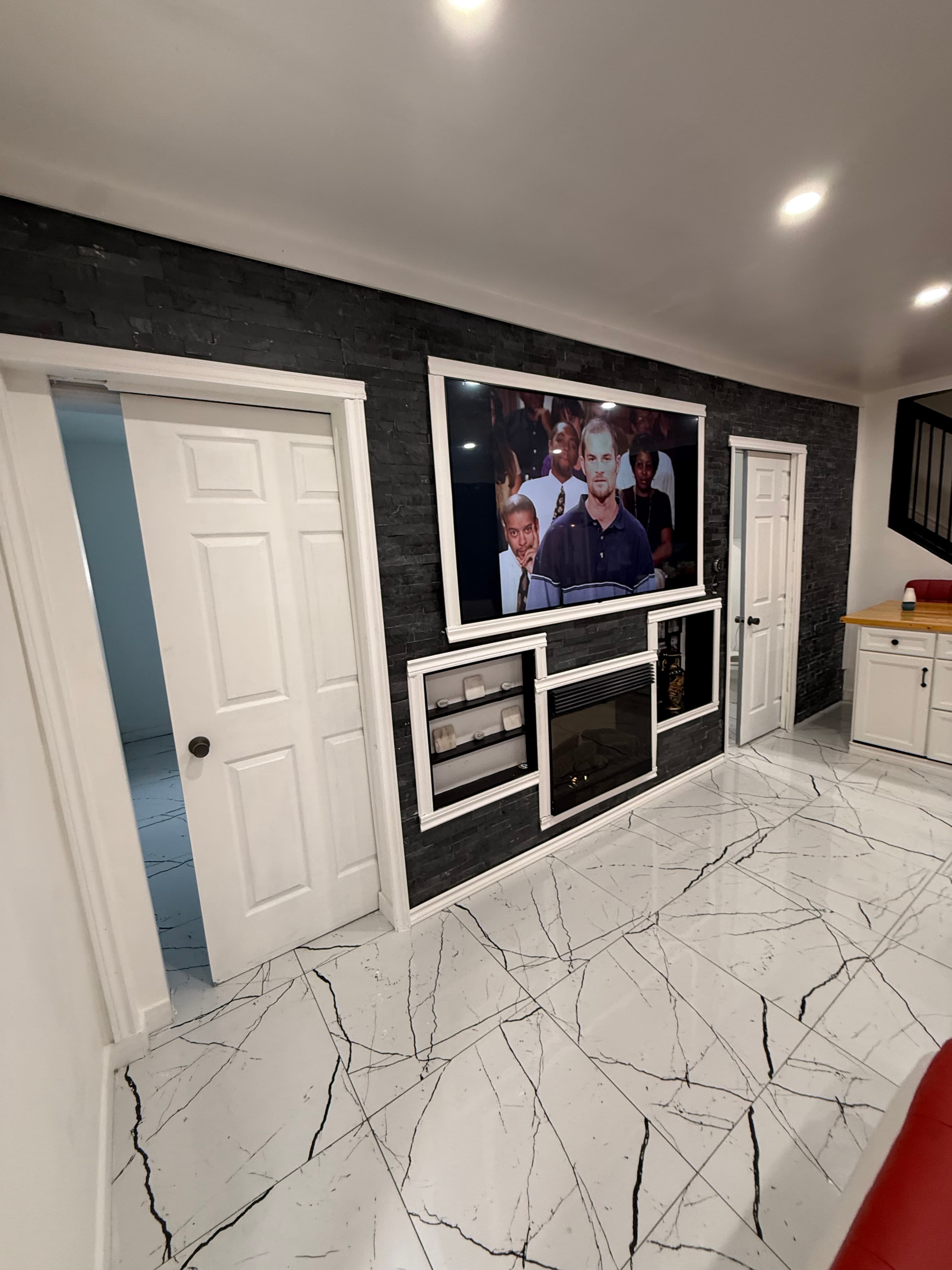 Living room with feature wall and TV niche.